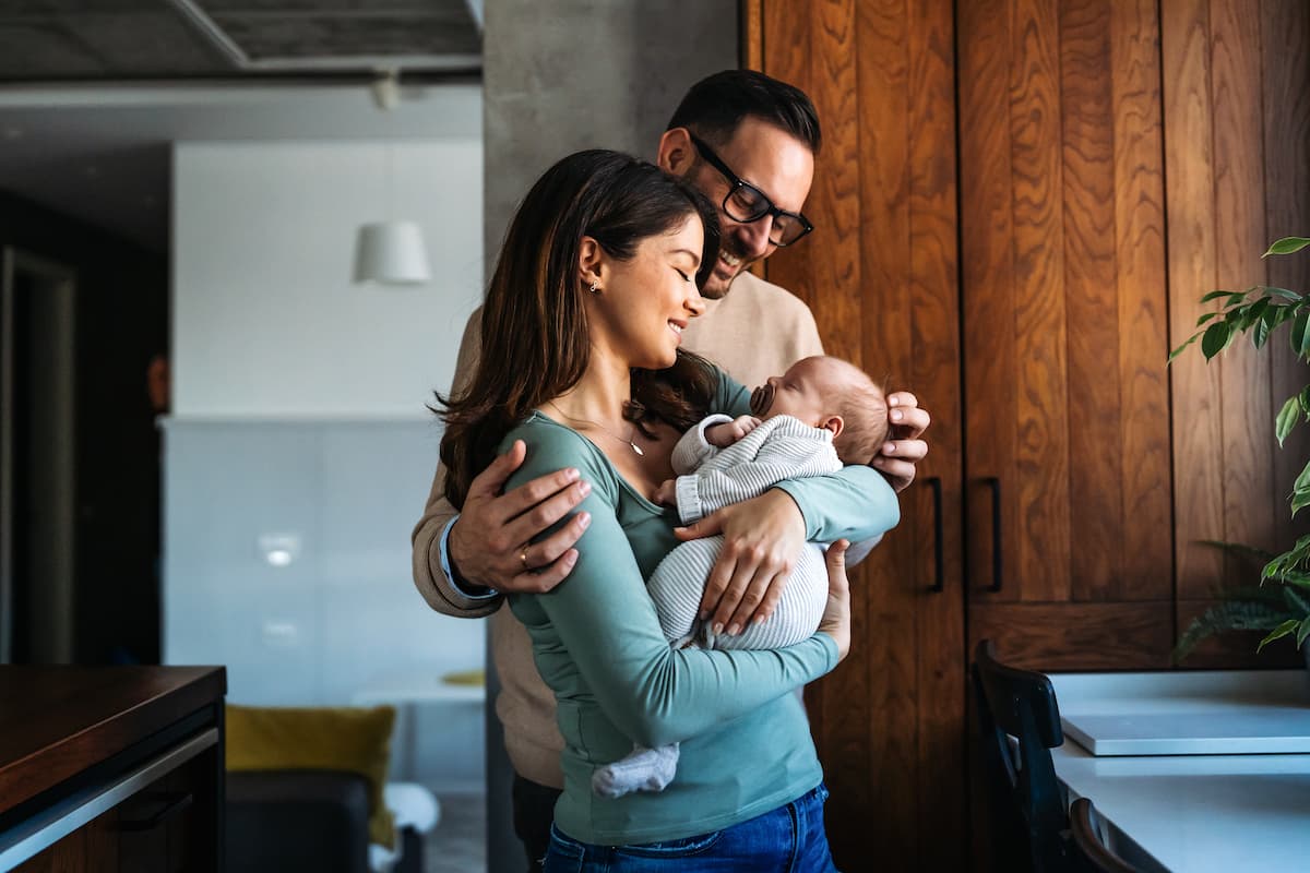 Young couple holding a baby