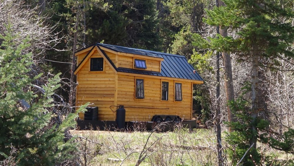 cozy rustic tiny home on wheels in the woods
