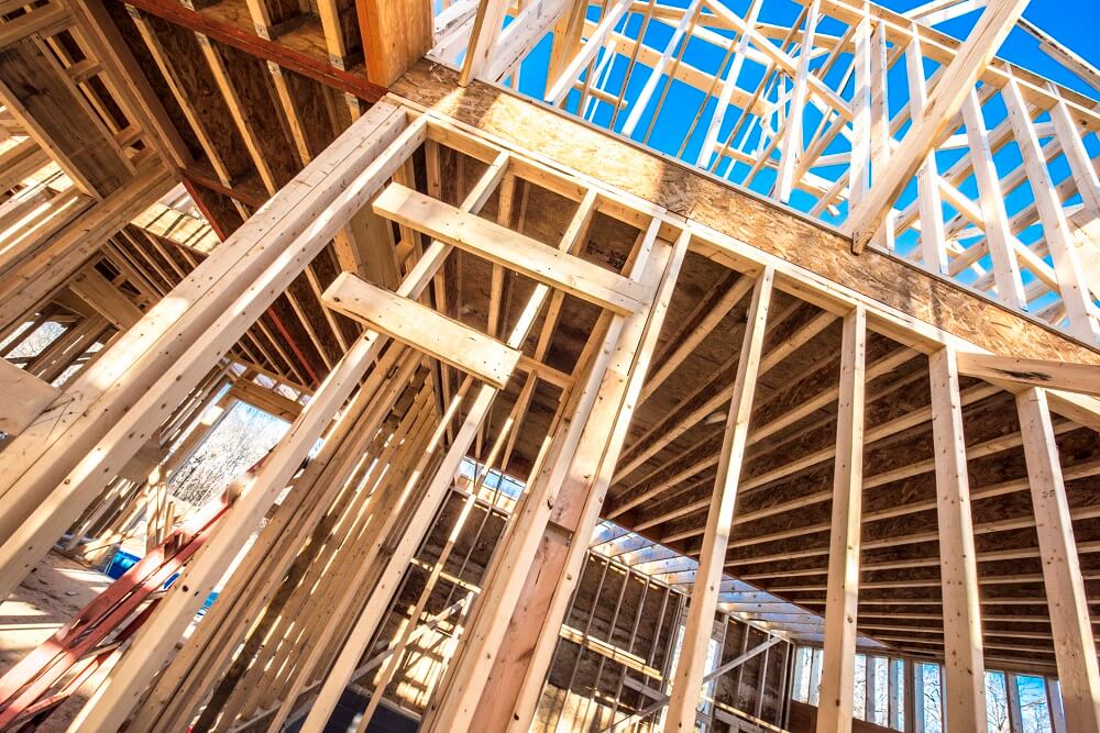 Upward shot of framed house interior under construction