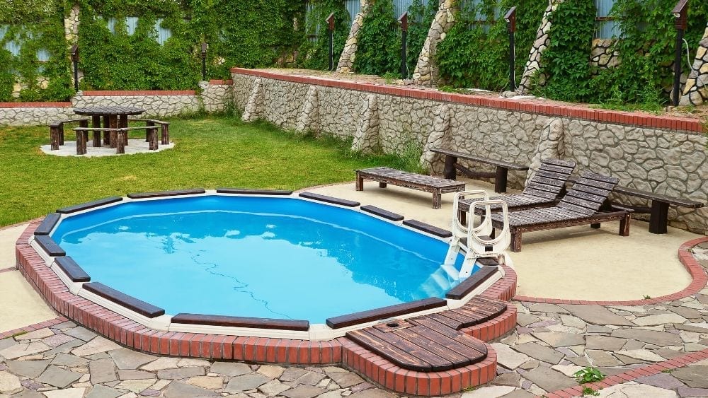 Backyard pool with rock deck and seating