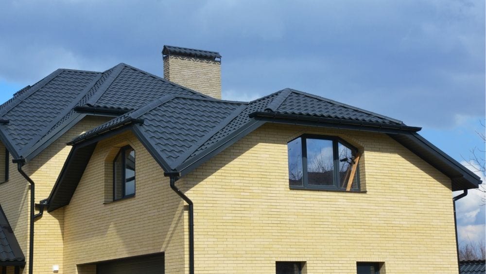 Large home with a black ceramic roof.