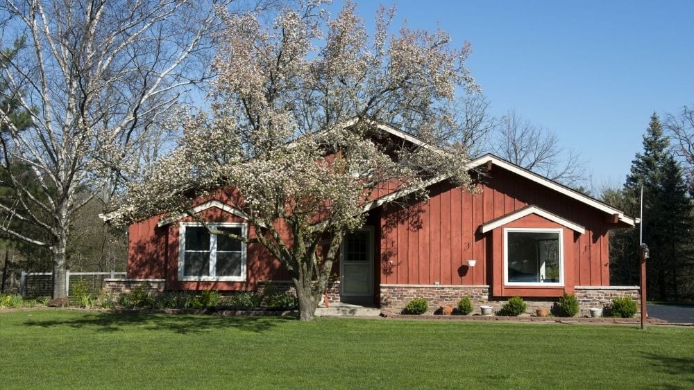 A ranch-style home with vertical red cedar wood siding.