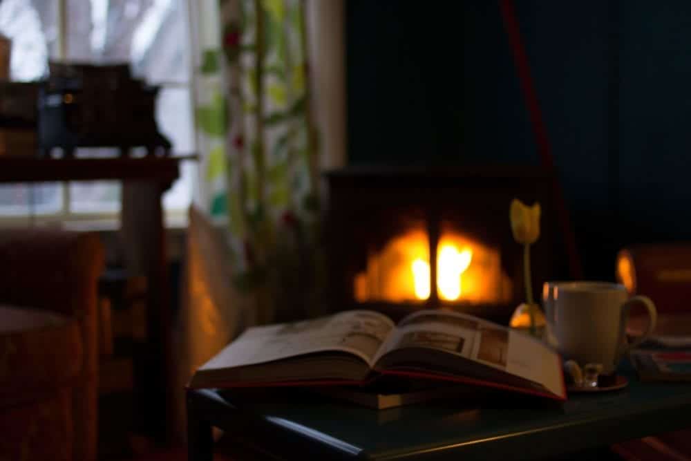 a-book-in-front-of-a-fireplace