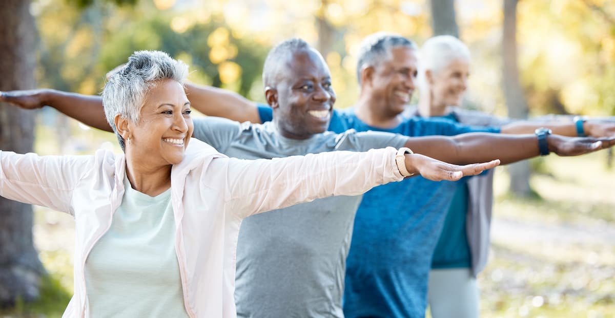 elderly group of friends stretching for outside yoga