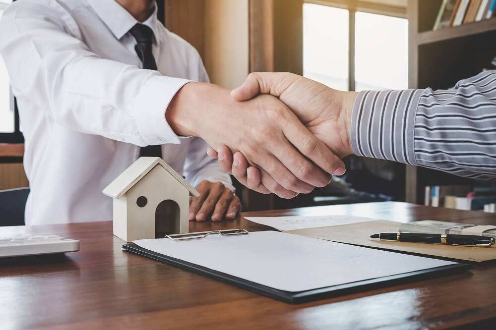 shaking-hands-over-house-contract