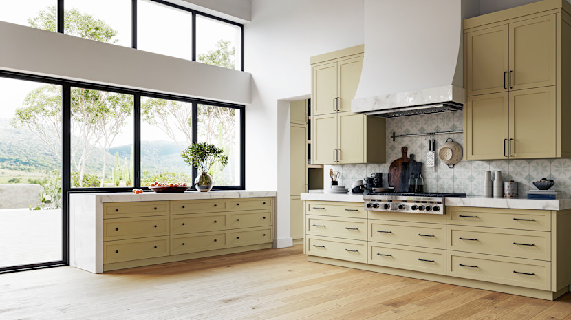 Open kitchen with side island, maple cabinets, black framed window and curved plaster hood fan