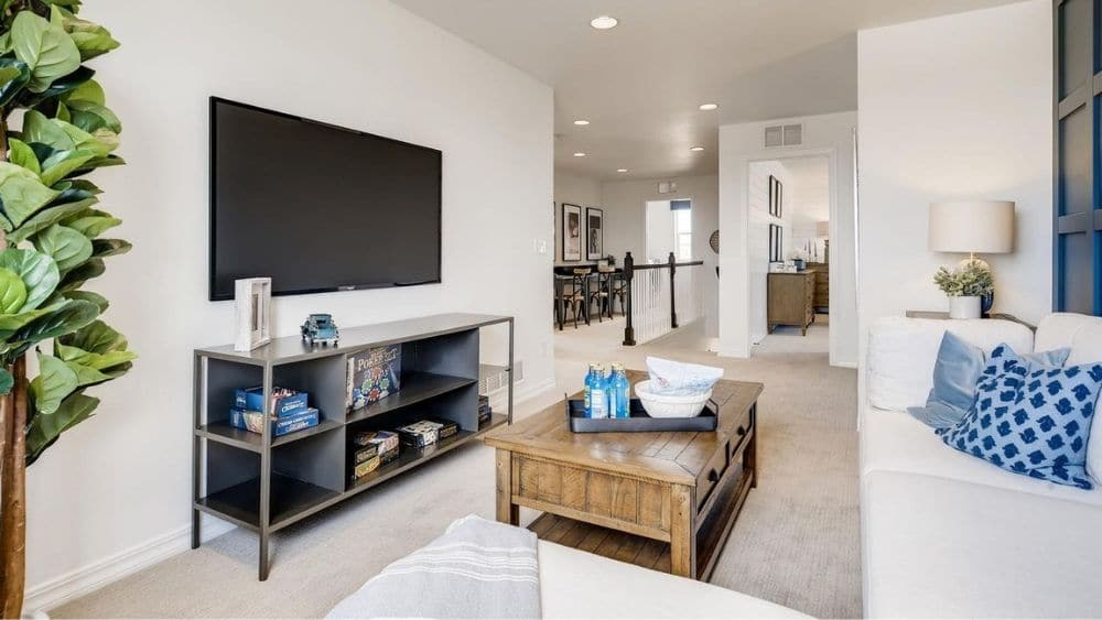 Modern living room with white and wood furniture.
