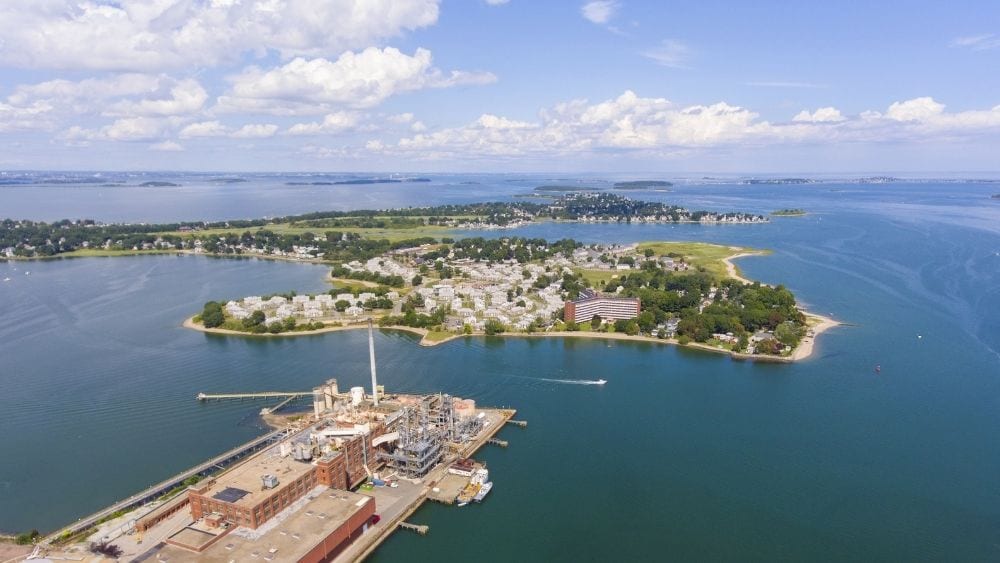 Aerial view of an small city on an island in a harbor.