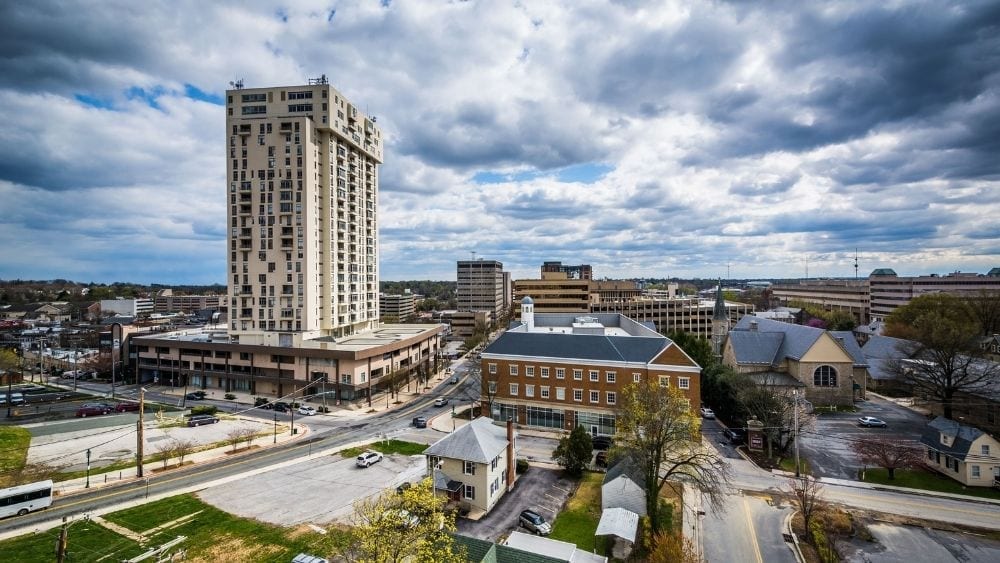 Aerial view of a city with lots of parks and one tall, modern building.