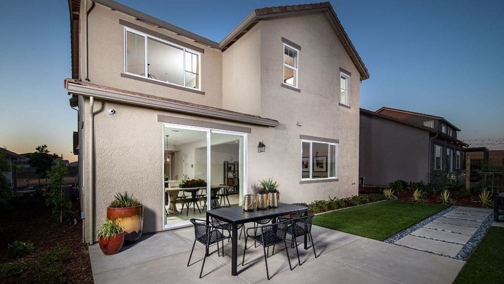 Rendering of a two-story home with a welcoming backyard.