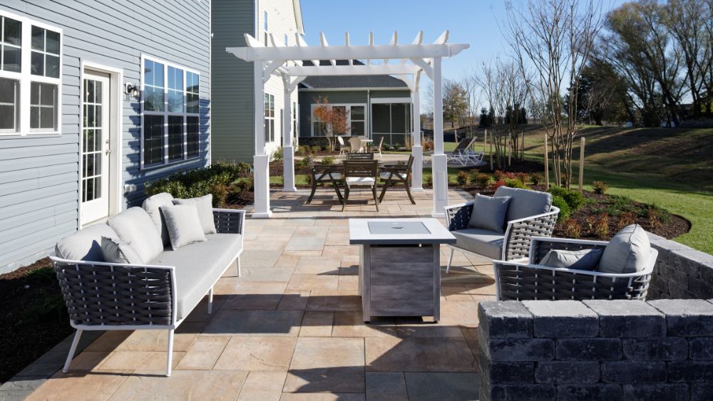 Patio with pergola and two separate seating areas, with a dining area and a outdoor living room