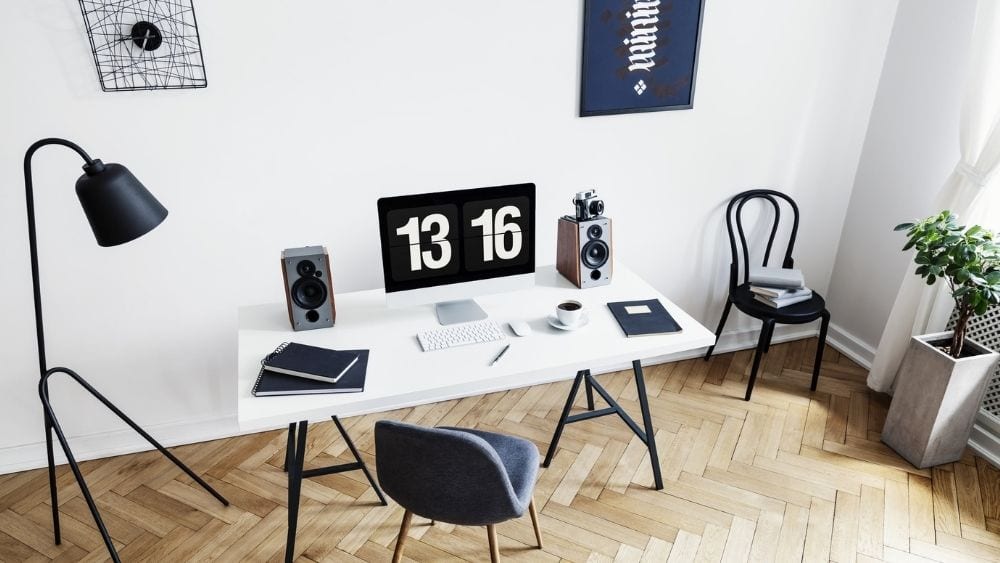 Angled view from above of a modern office with a black floor lamp in the corner.