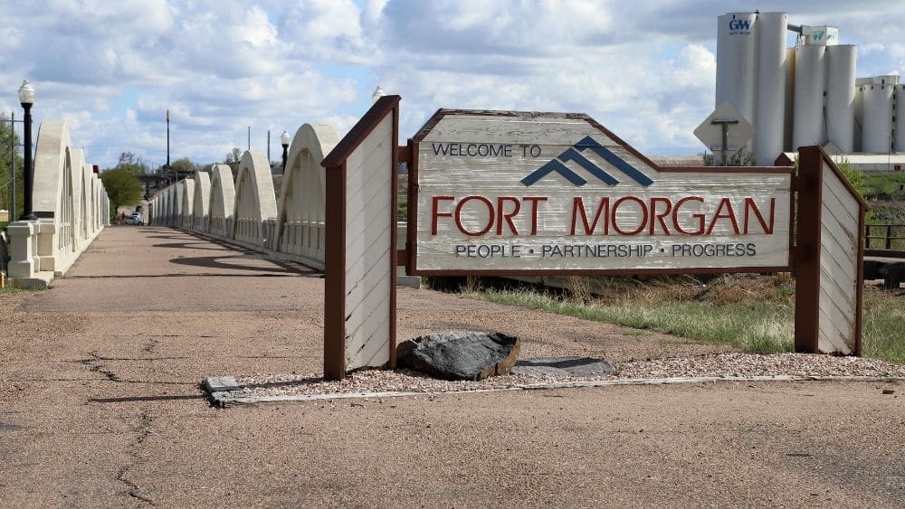 road sign that says fort morgan and below says “people, partnership, progress”