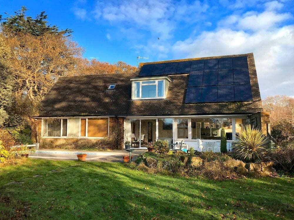 Exterior of home with solar panels on roof