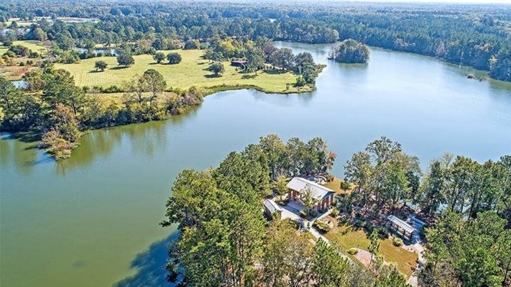 Aerial view of a waterway splitting a suburban community.
