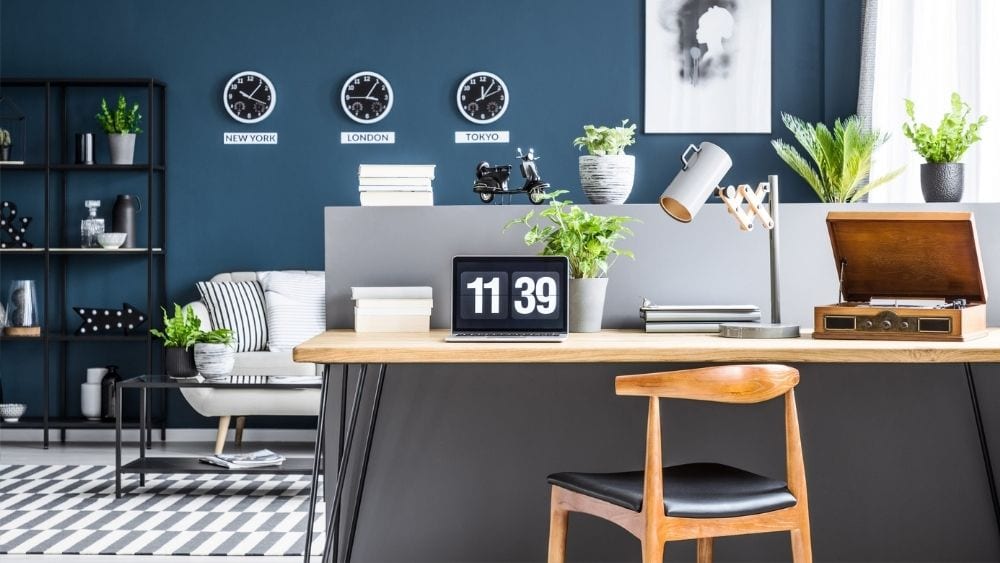 Desk against a half-wall, with the living room in the background.