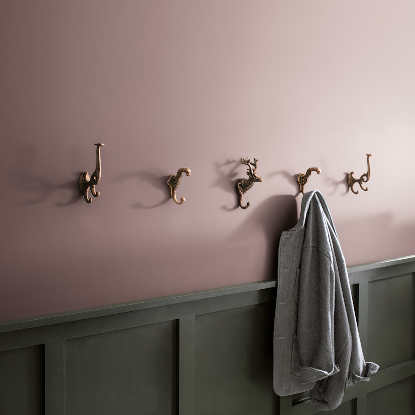 Foyer painted in Benjamin Moore's Cinnamon Slate, with animal-themed coat hooks and wainscotting
