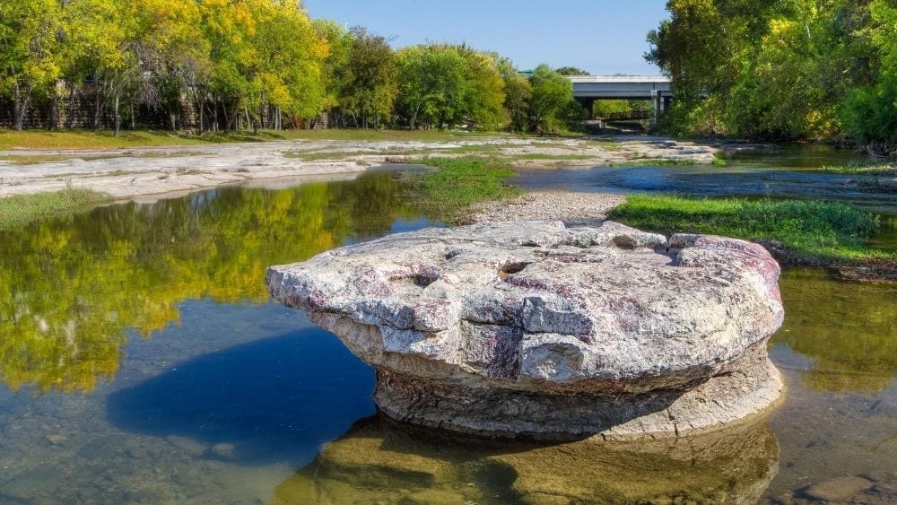 A round rock in a river bed; Round Rock’s namesake.