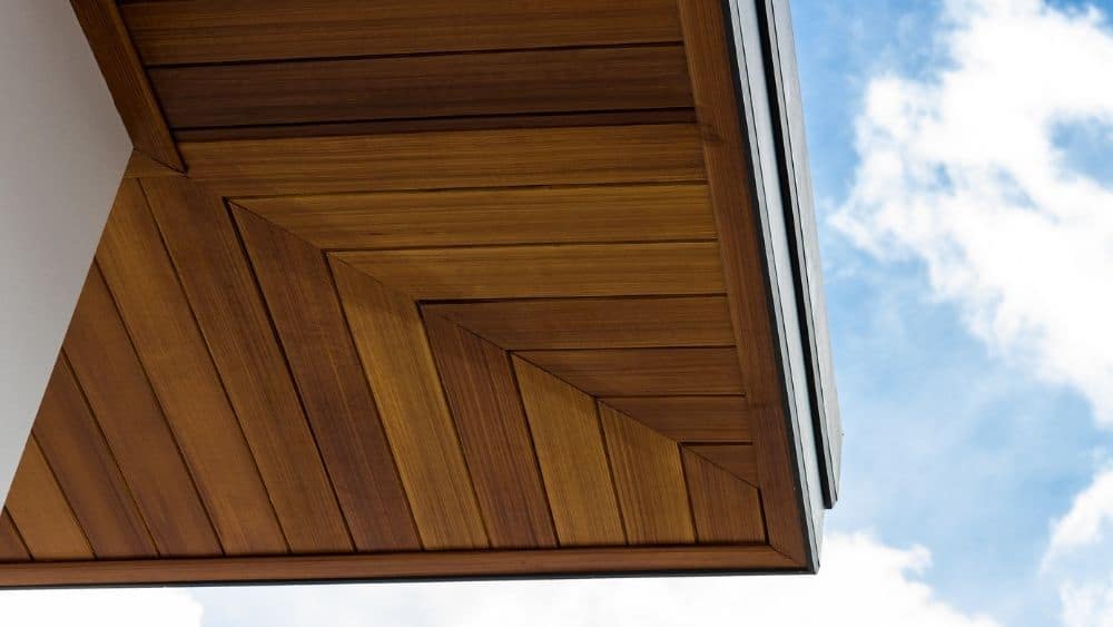Fiber cement paneling made to look like hardwood lining the bottom of the roof.