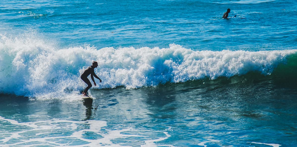 surfers catching waves in the Pacific Ocean