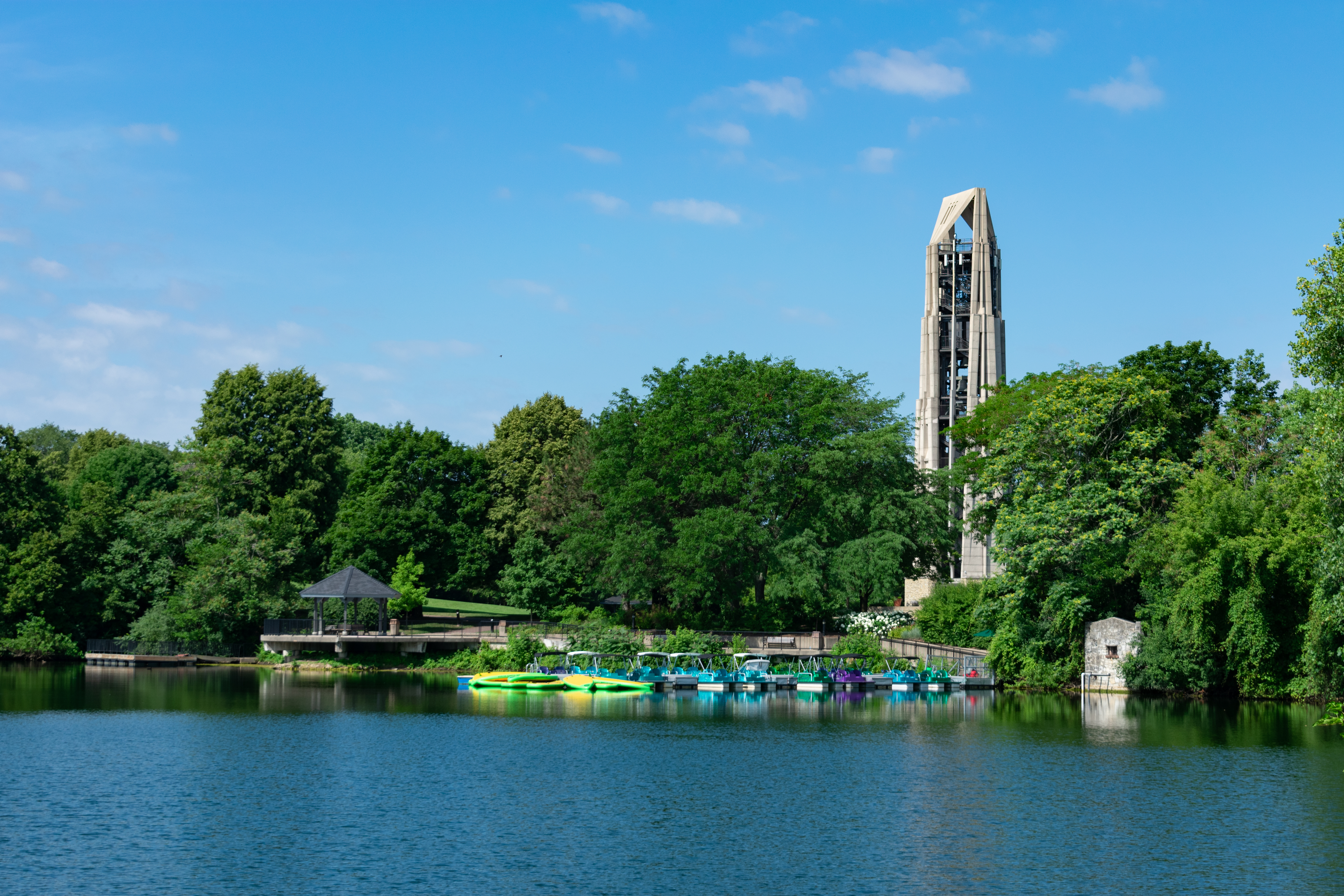 kayaks docked at riverwalk area of tree lined Quarry Lake