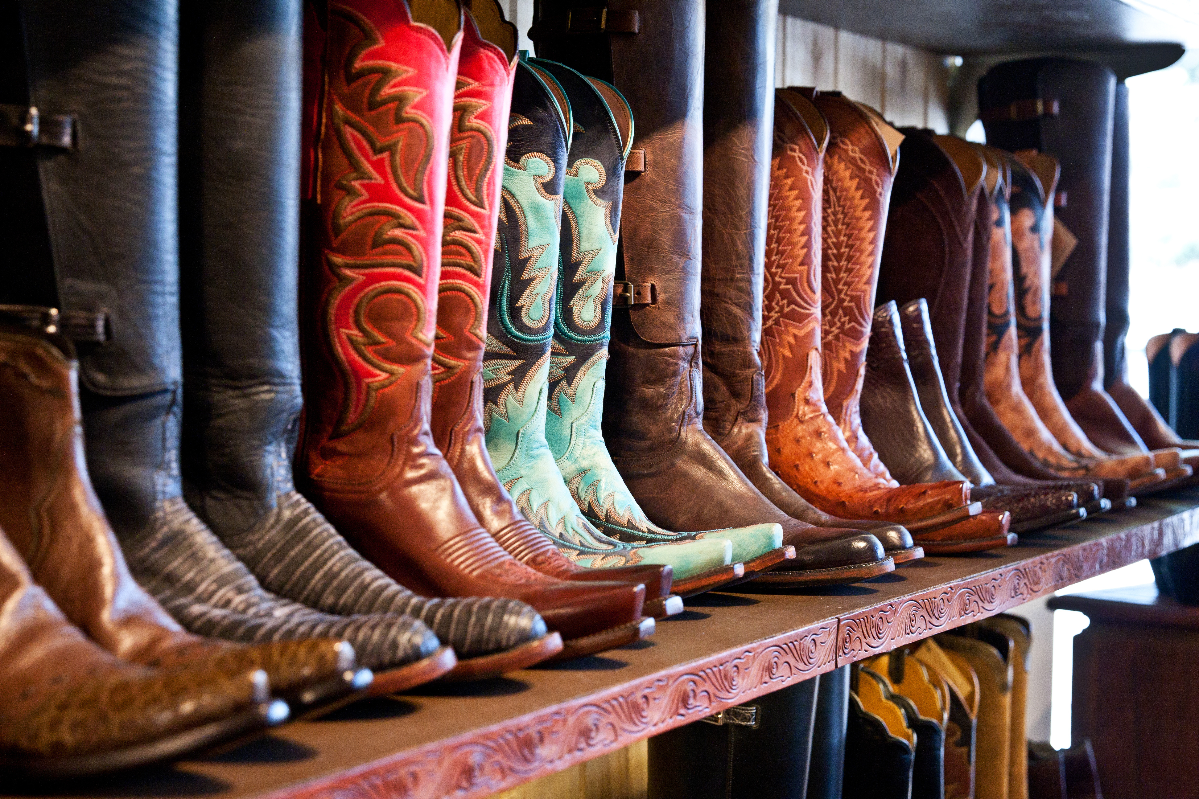 cowboy boots aligned on shelf