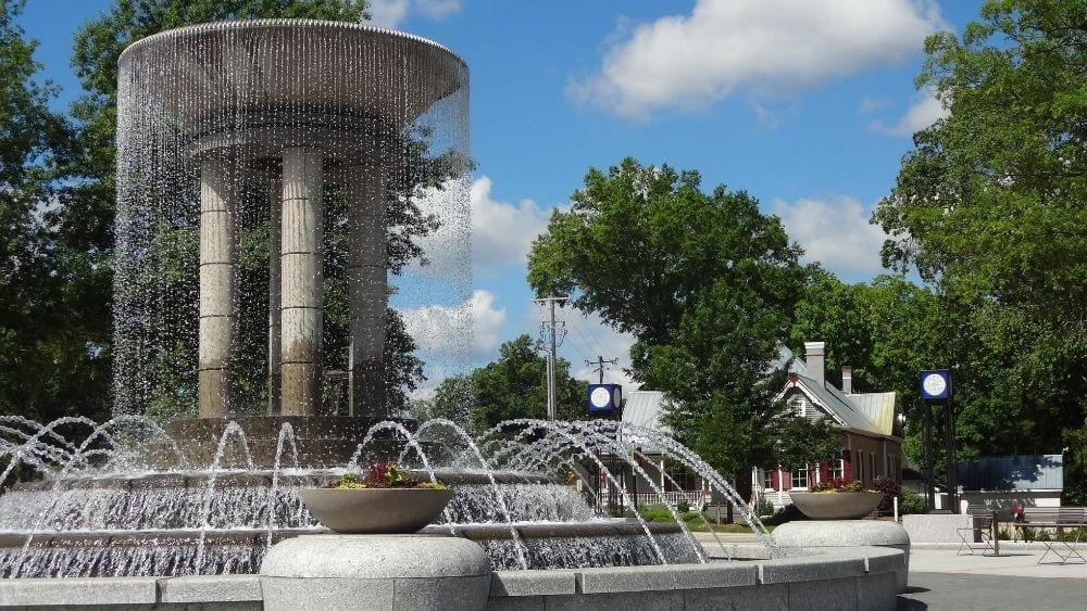A concrete water fountain in a park courtyard.
