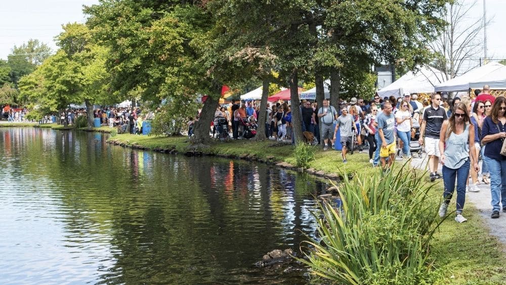 People visiting vendors at a farmer’s market in Babylon, New York.