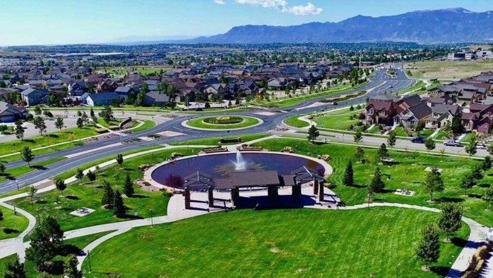 View of a suburban community with a fountain in the middle.