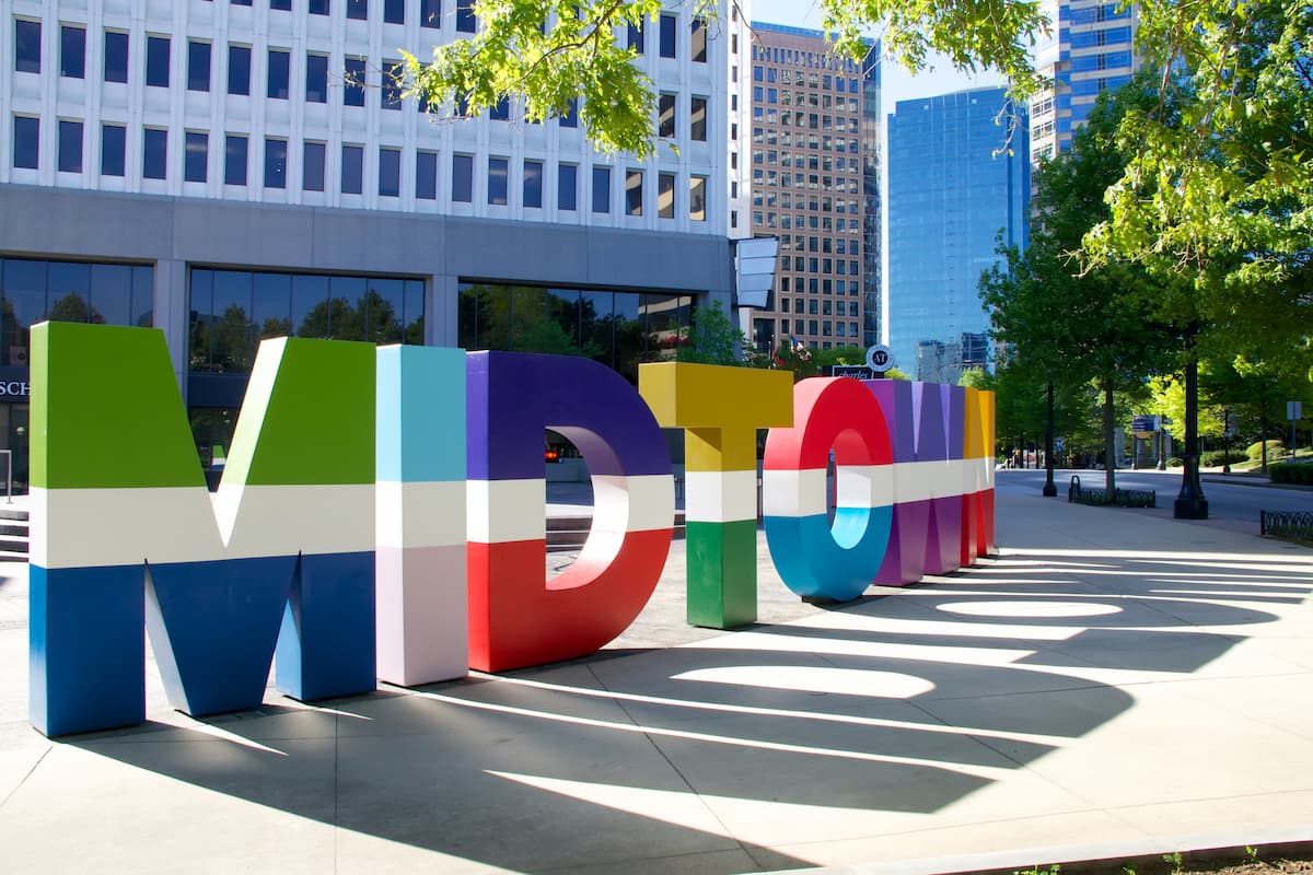 Colorful Midtown Sign surrounded by buildings 