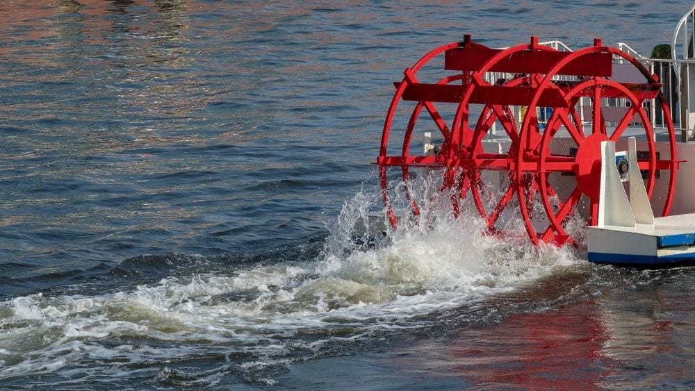 A paddle steamer boat moving through the water.