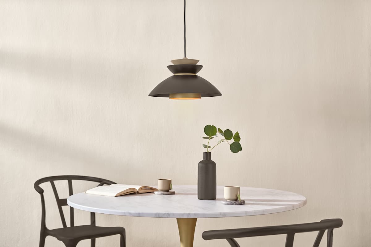 A light fixture, chairs and vase spray painted in Matte Coffee Bean, Krylon's Paint Color of the Year for 2026