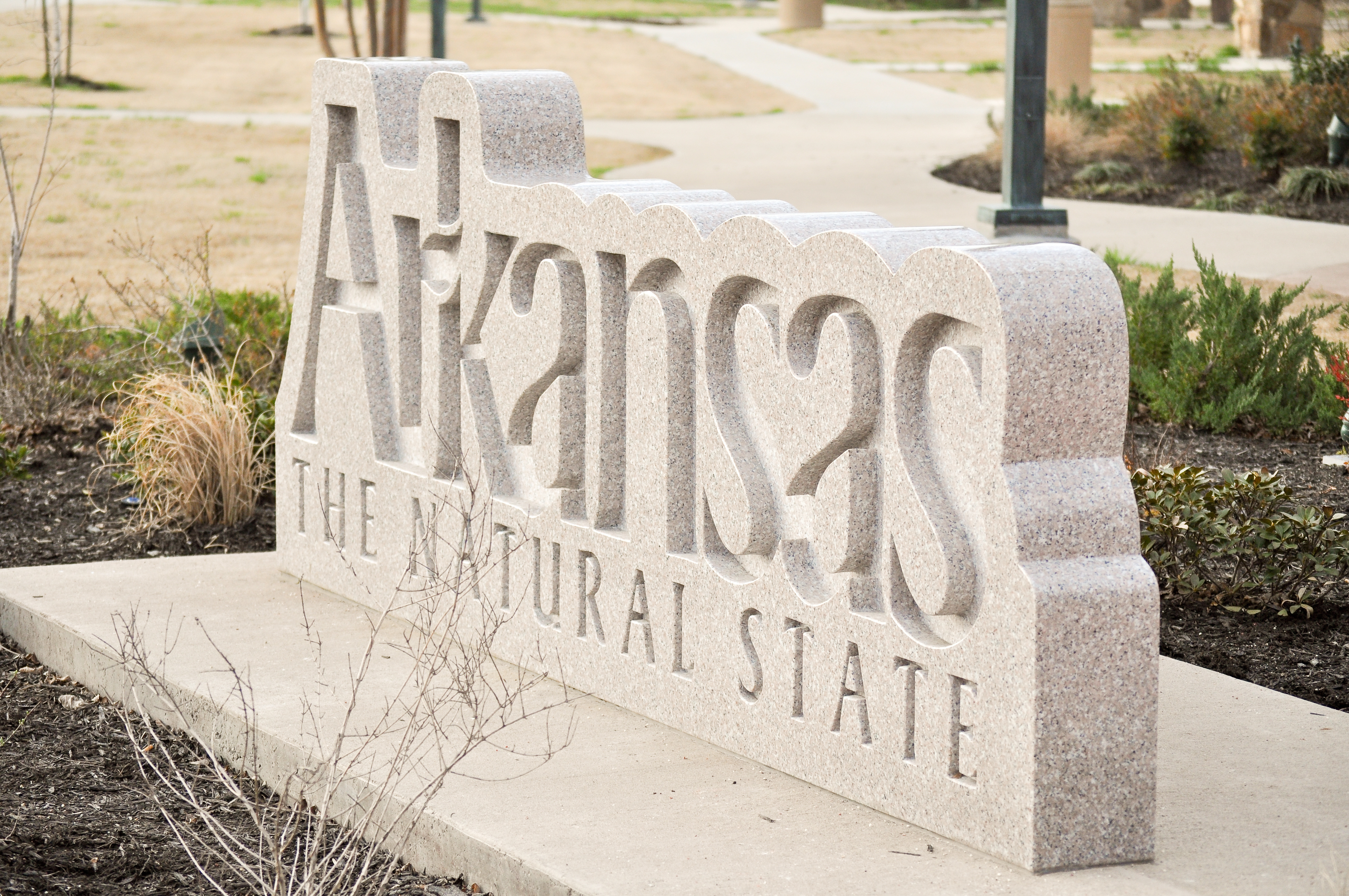 White stone marker with Arkansas The Natural State carved in it