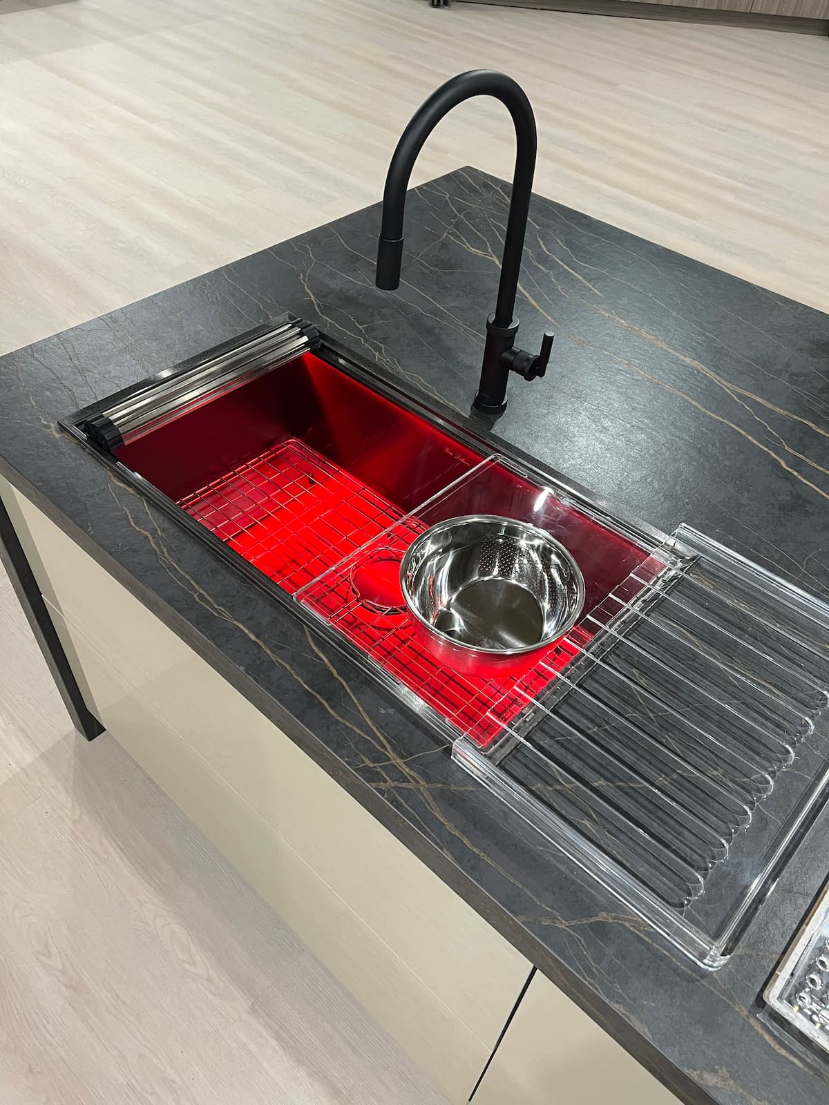 Black countertop with workstation sink, with red insert