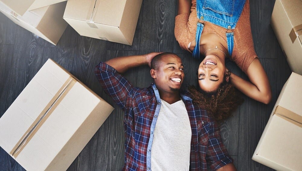 couple-lying-down-with-moving-boxes