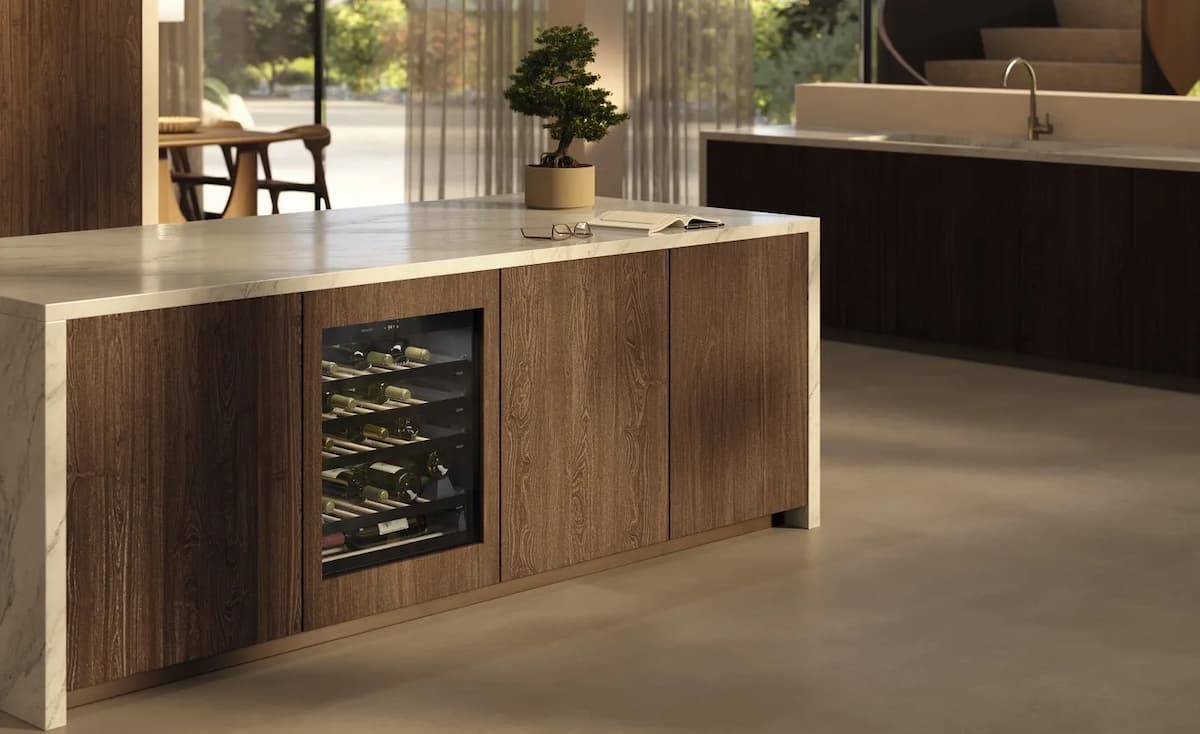 Miele wine fridge, set inside a kitchen island with brown paneling