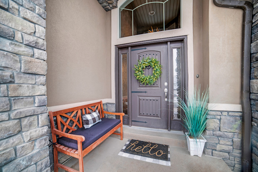 Blue front door with wreath and transom window, with side lights