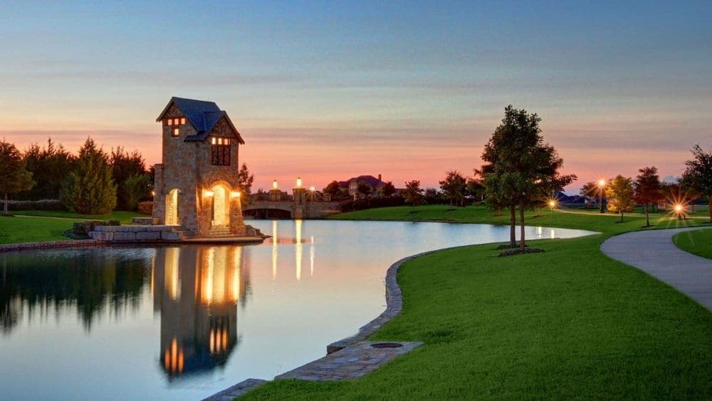 A lake with a small watchtower and sidewalks around it.