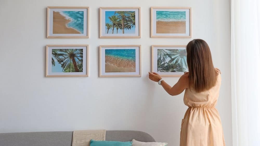woman decorating wall in bedroom