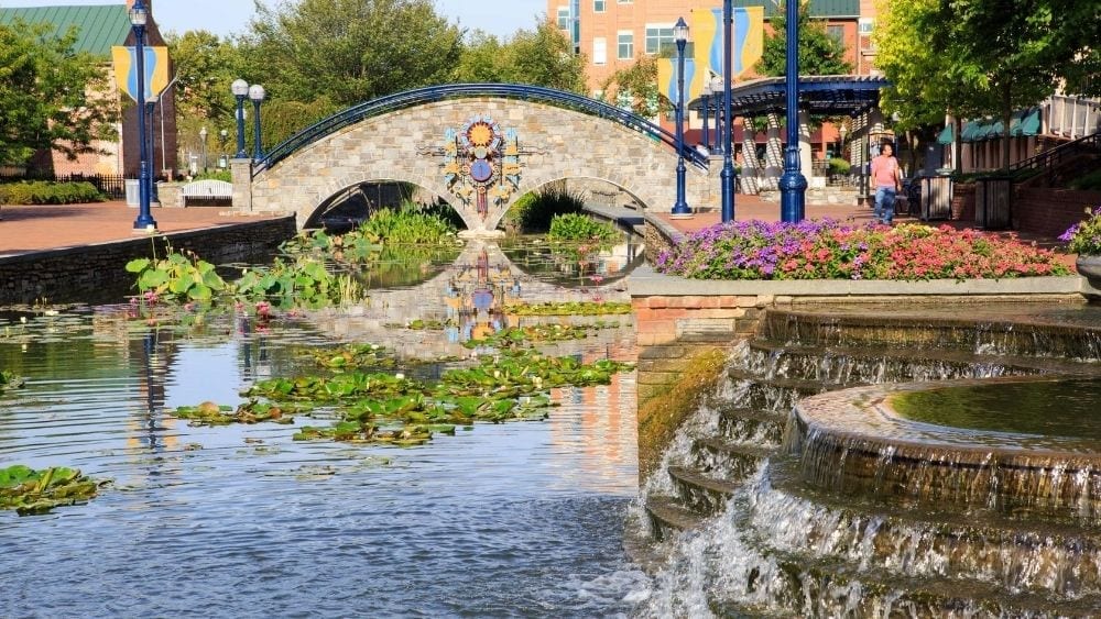 A stone bridge over a man-made river.