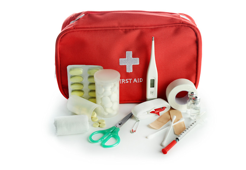 Red first aid kit with thermometer, gauze, medical tape, cotton swabs and scissors
