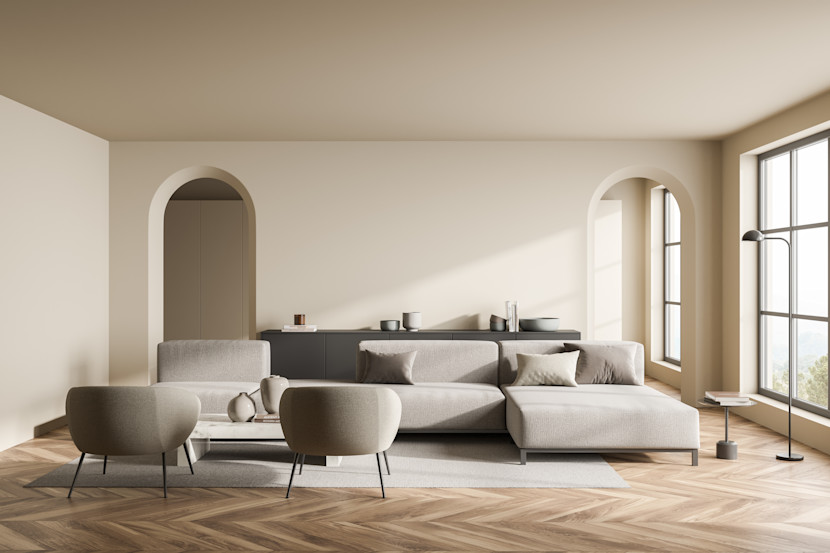 Monochromatic living room with curved doorways, round chairs and sofa