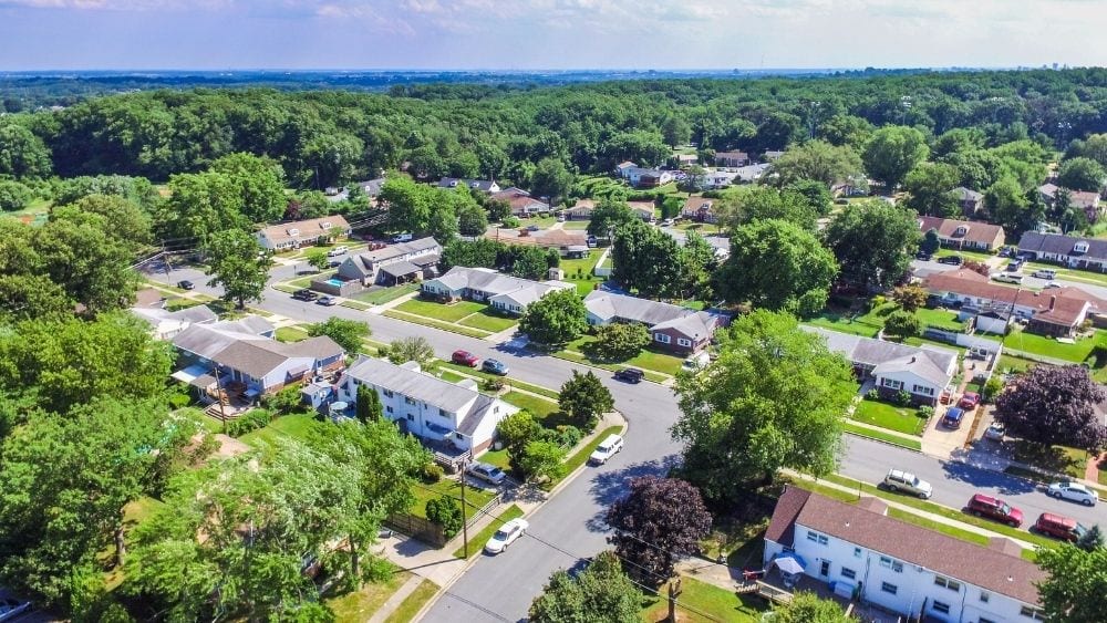 Aerial view of a suburban area with houses and trees.