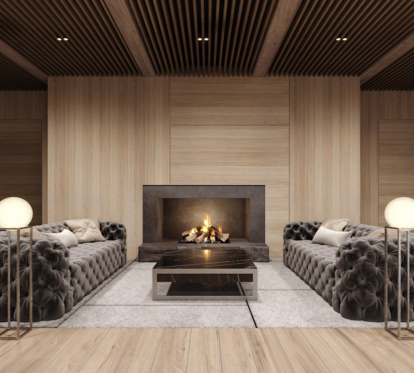Modern gas fireplace focal point, with wood surround, and two tufted grey sofas facing each other with a coffee table in the middle 