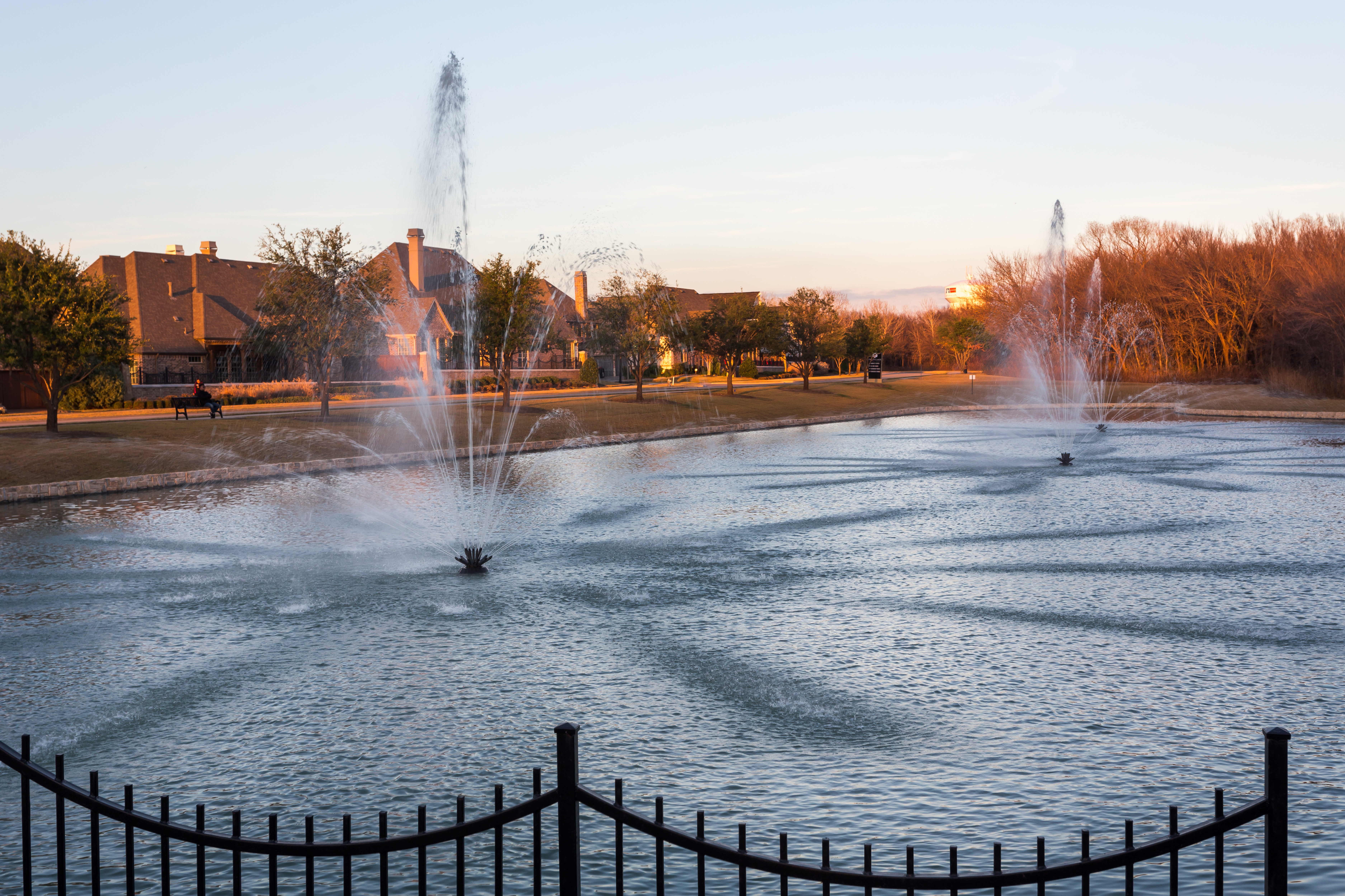 Fountains in park with benches and walkway
