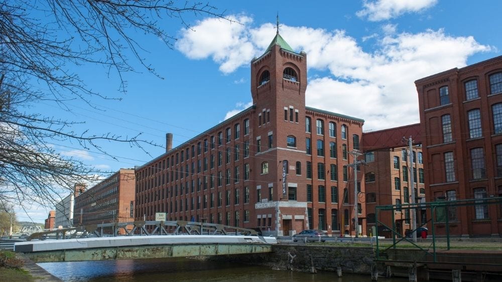 Angled view of a large historic building made from red brick.