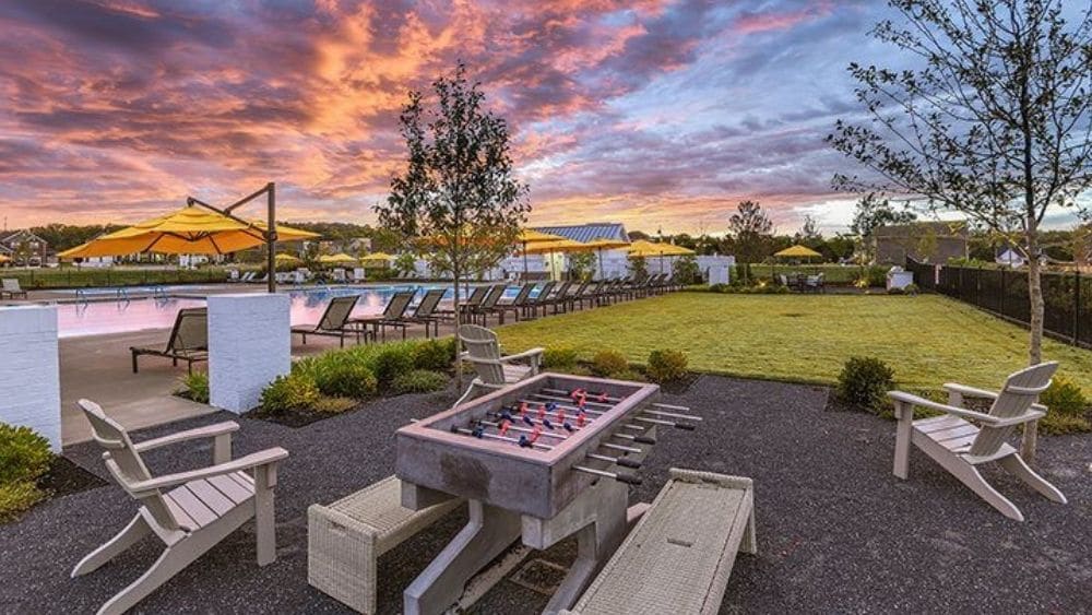 View of a pool with chairs nearby.