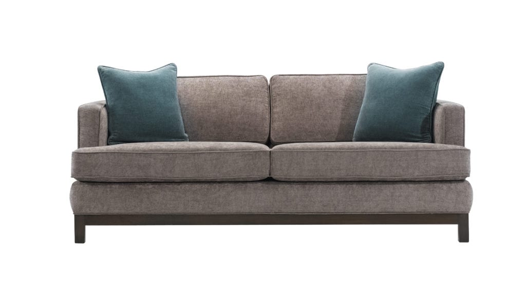 Gray sofa with velvet teal pillows.