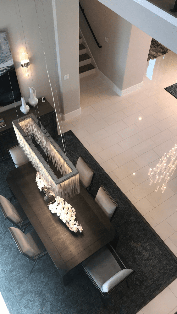 an overhead shot of a dining table and kitchen area of a Drees model home in the Travisso community
