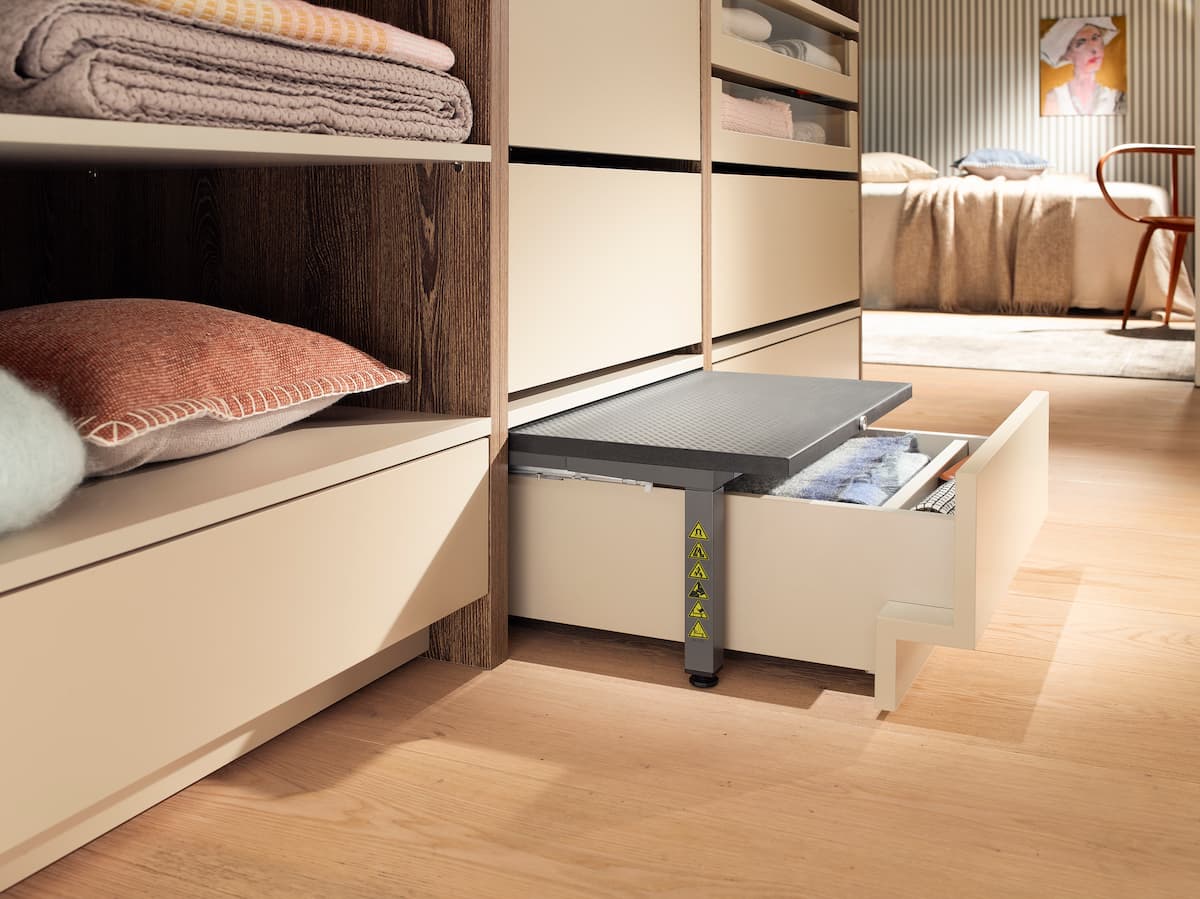 lower drawer in cabinetry pulled out, with a step stool built in.